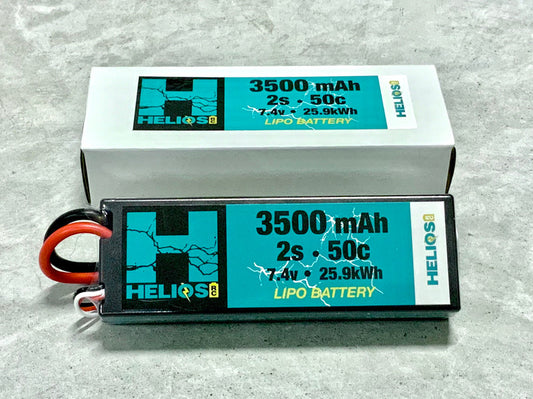 Two Helios 2S 3500 mAh 50c Lipo batteries, one standing upright and the other lying on its side, with visible branding and capacity markings. -1