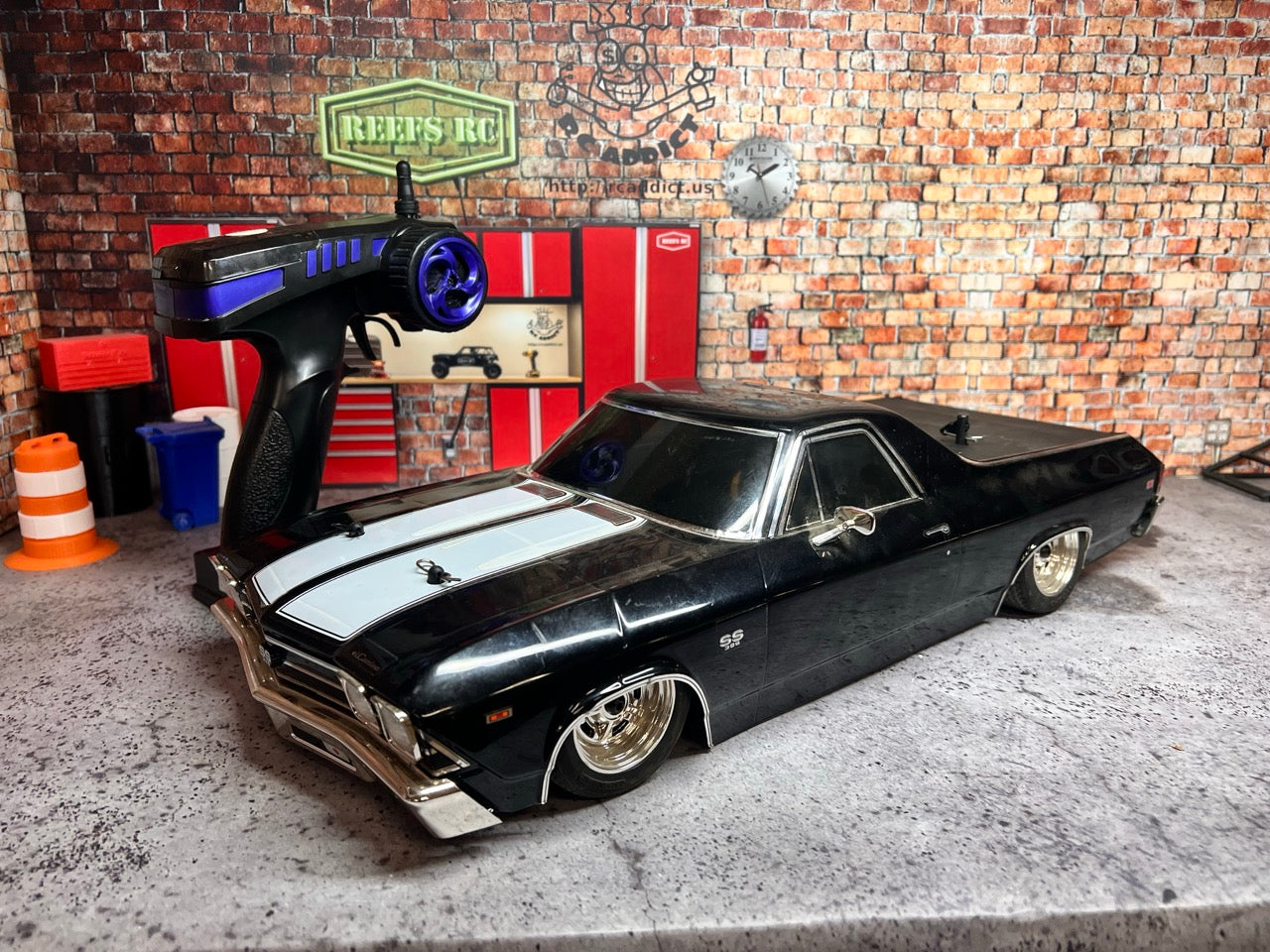 Kyosho Fazer Mk2 Touring Car/Chassis RTR on a concrete floor with a brick wall background