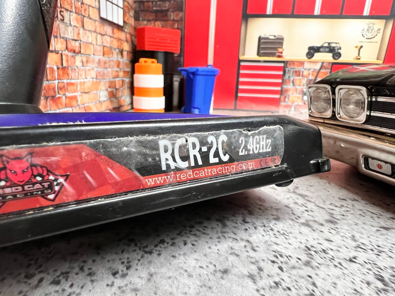 Close-up of a Kyosho Fazer Mk2 Touring Car/Chassis RTR with 'Red Cat Racing' branding in a garage setting. 2