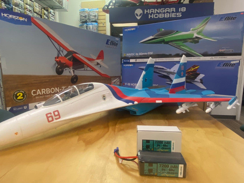 6s 7200 mah battery sitting in front of an rc plane