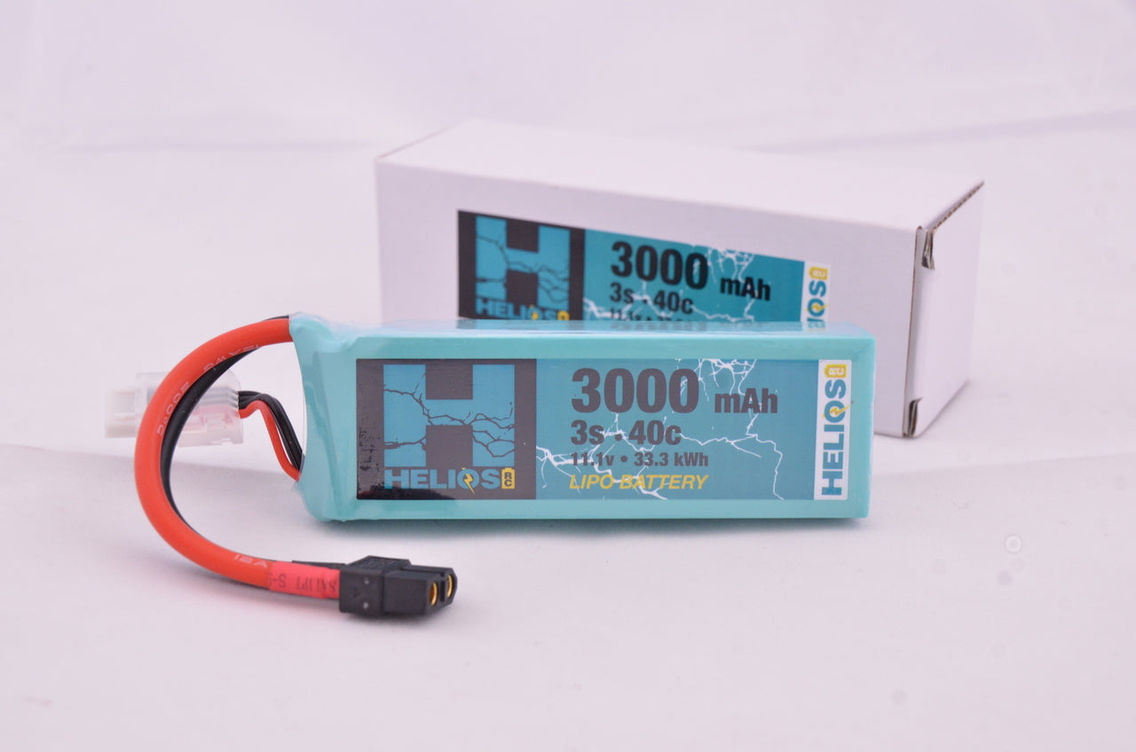 A blue 3000 mAh Helios RC Lipo battery pack with red wiring and a label displaying capacity and voltage information.