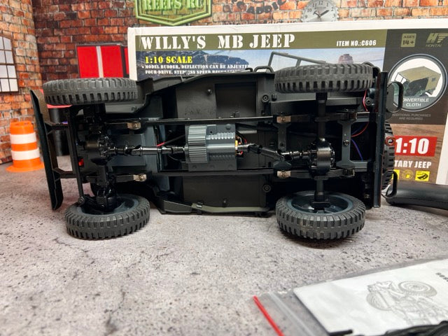 Model of a Willy's MB Jeep with detailed mechanical components on a concrete floor.